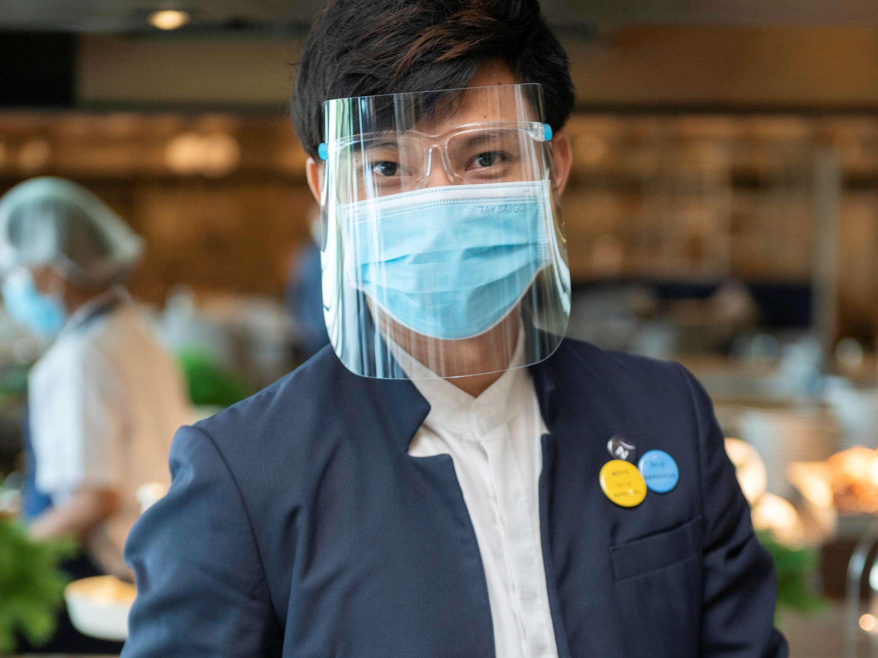 Novotel Chennai Sipcot Ngoại thất bức ảnh A Thai Airways employee wearing a face shield